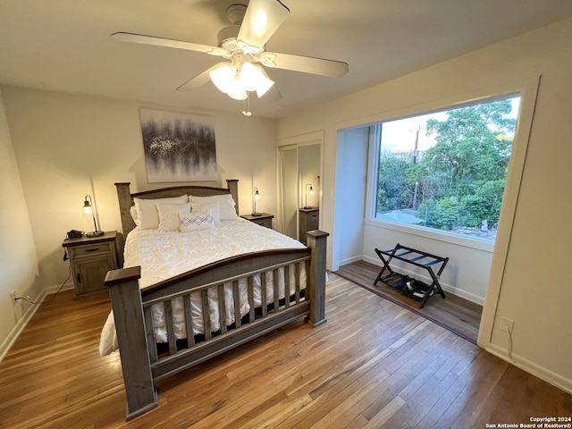 bedroom with hardwood / wood-style flooring, ceiling fan, and a closet