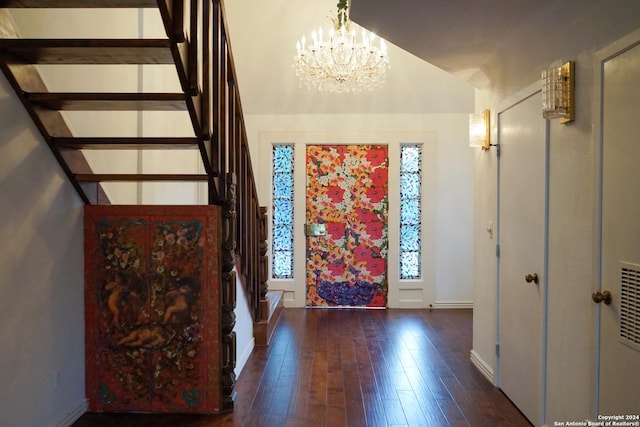 foyer with a chandelier and dark hardwood / wood-style floors