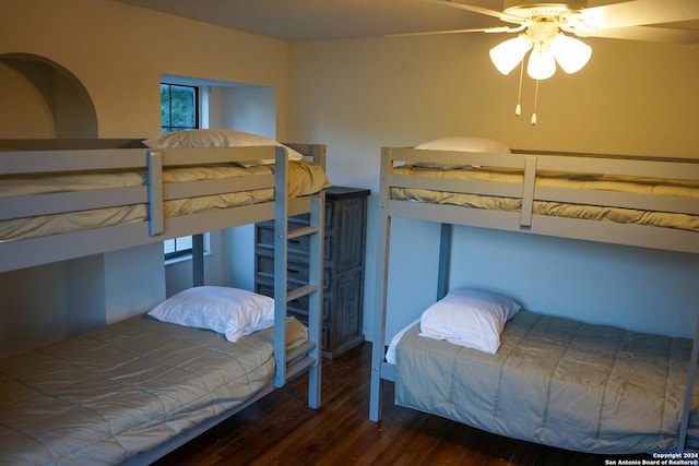 bedroom with ceiling fan and dark hardwood / wood-style floors