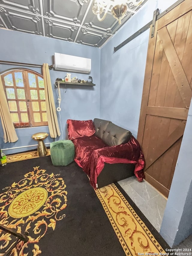 living room featuring a barn door and a wall mounted AC