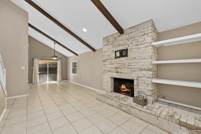 unfurnished living room with light tile patterned floors, vaulted ceiling with beams, a brick fireplace, and ceiling fan