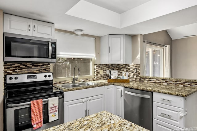 kitchen featuring sink, white cabinetry, and stainless steel appliances