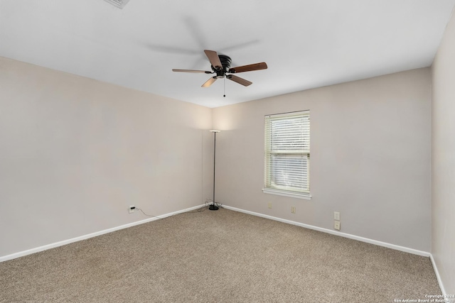 spare room featuring carpet flooring and ceiling fan