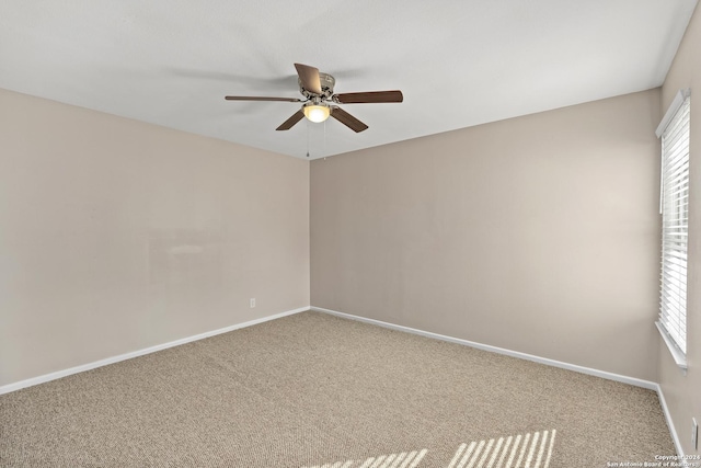 spare room with carpet flooring and ceiling fan