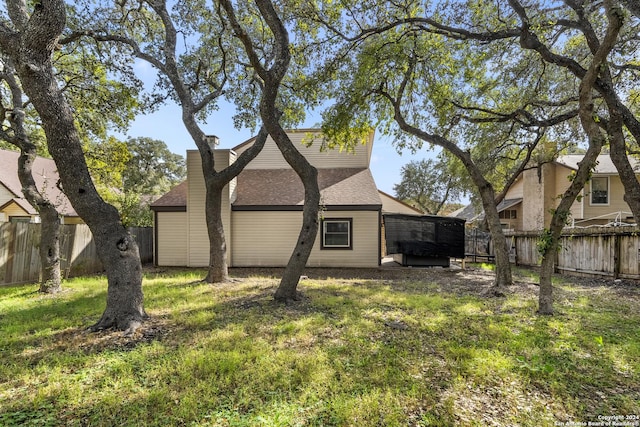 rear view of house with a yard