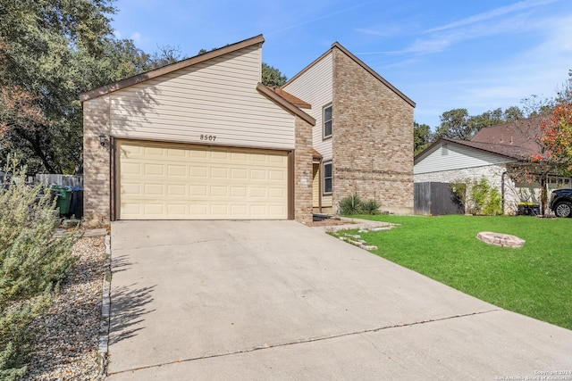 view of front of house with a garage and a front lawn