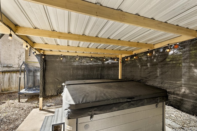 view of patio featuring a trampoline and a hot tub