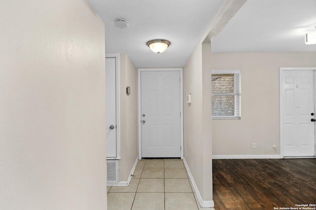 doorway with light tile patterned floors