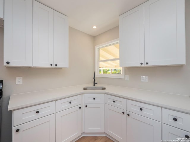 kitchen with white cabinetry and sink