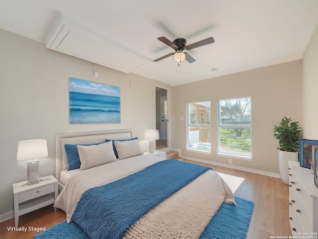 bedroom with ceiling fan and light hardwood / wood-style floors