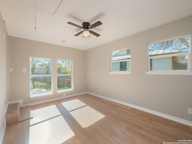 spare room with light hardwood / wood-style floors and ceiling fan