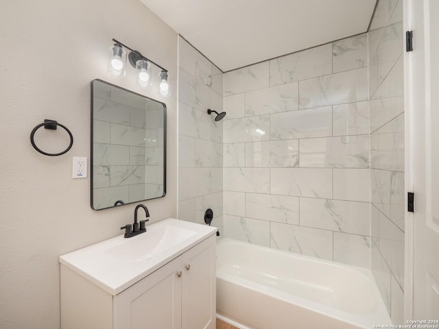 bathroom featuring tiled shower / bath combo and vanity