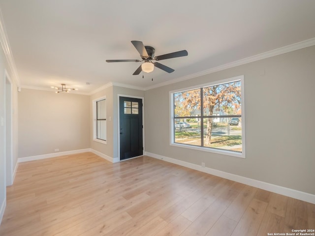 unfurnished room featuring ceiling fan, crown molding, and light wood-type flooring