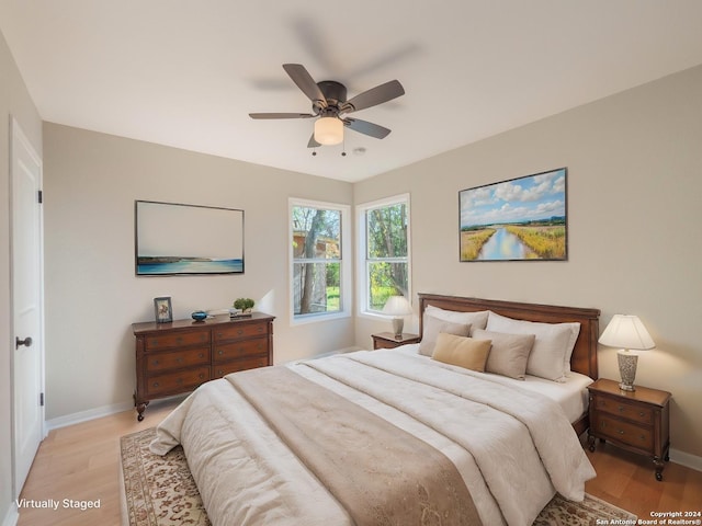 bedroom with ceiling fan and light hardwood / wood-style flooring