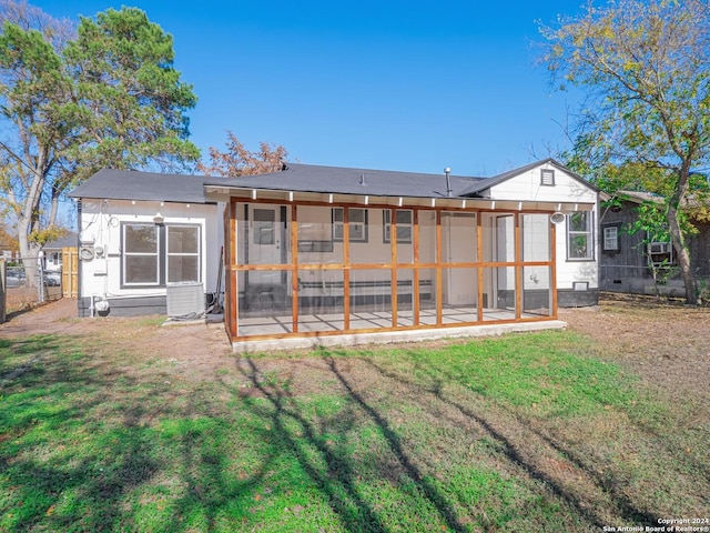 back of house featuring a sunroom and a yard