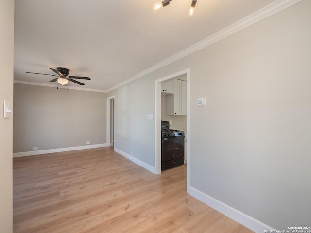 spare room featuring crown molding, ceiling fan, and light wood-type flooring