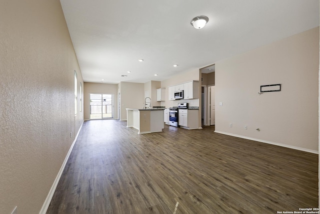 unfurnished living room with dark hardwood / wood-style flooring and sink