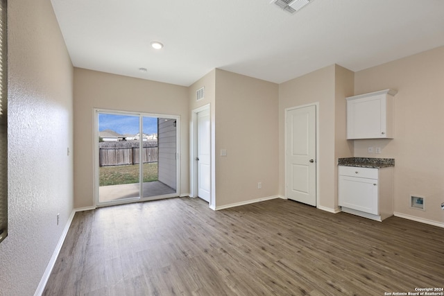 unfurnished living room with dark hardwood / wood-style flooring