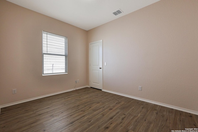 spare room with dark hardwood / wood-style floors