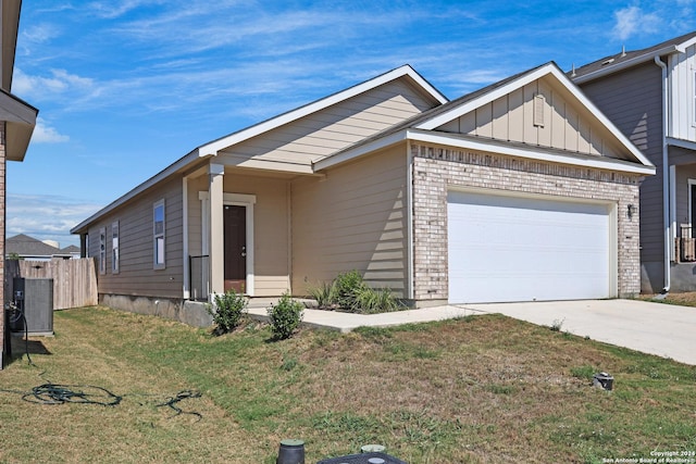 view of front of house featuring a front yard and central air condition unit