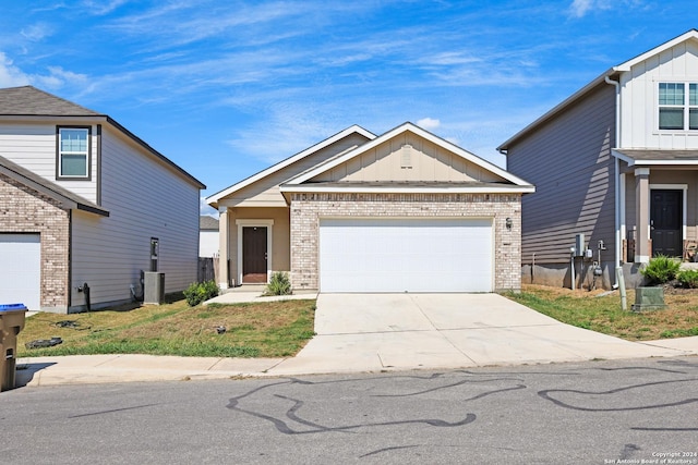 view of front of house featuring a garage and cooling unit