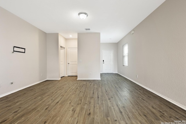 unfurnished room with dark wood-type flooring