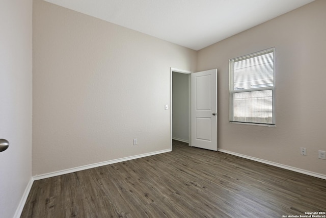 empty room featuring dark wood-type flooring