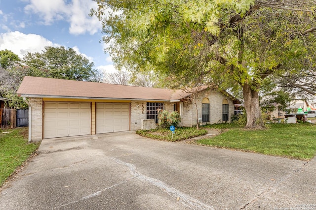 view of front of property with a front lawn and a garage