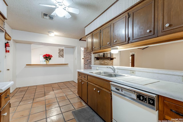 kitchen featuring ceiling fan, dishwasher, sink, a textured ceiling, and light tile patterned floors