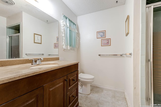 bathroom featuring walk in shower, tile patterned flooring, a textured ceiling, toilet, and vanity