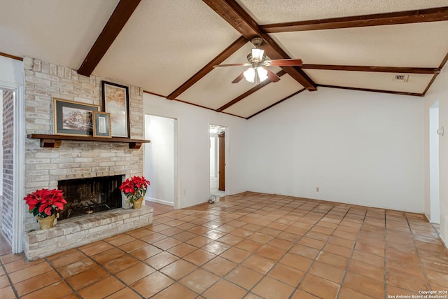 unfurnished living room featuring ceiling fan, tile patterned flooring, lofted ceiling with beams, a textured ceiling, and a fireplace