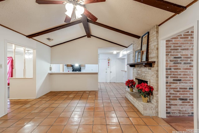 unfurnished living room with a textured ceiling, lofted ceiling with beams, and ceiling fan