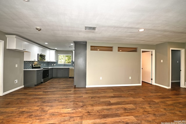 kitchen featuring tasteful backsplash, stainless steel appliances, dark wood-type flooring, white cabinets, and gray cabinets