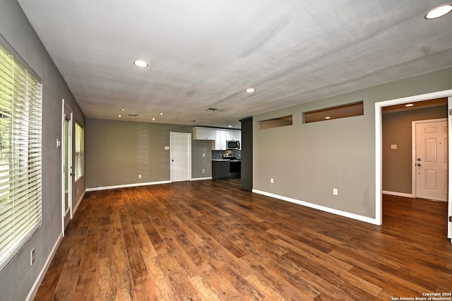 unfurnished living room featuring dark hardwood / wood-style flooring