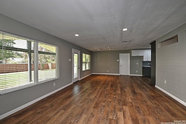 unfurnished living room with dark hardwood / wood-style floors