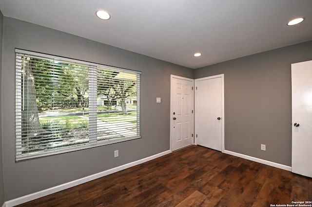 empty room featuring dark hardwood / wood-style floors and plenty of natural light