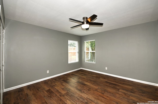 unfurnished room with ceiling fan and dark hardwood / wood-style flooring