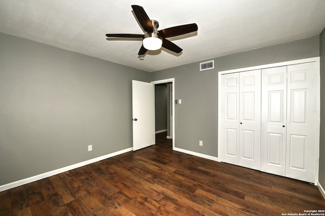 unfurnished bedroom with ceiling fan, dark hardwood / wood-style floors, and a closet