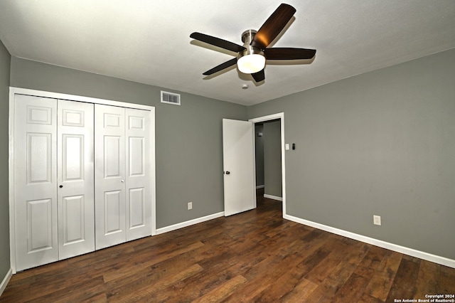 unfurnished bedroom featuring ceiling fan, dark hardwood / wood-style flooring, and a closet