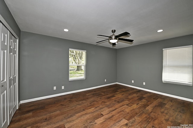 unfurnished bedroom with dark hardwood / wood-style flooring and ceiling fan