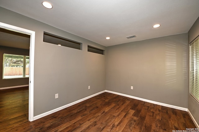 empty room with dark hardwood / wood-style flooring