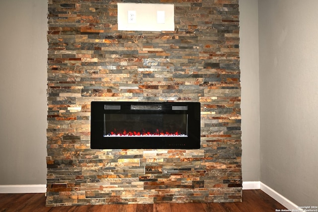 interior details featuring a fireplace and hardwood / wood-style flooring