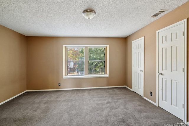 unfurnished bedroom with carpet flooring and a textured ceiling