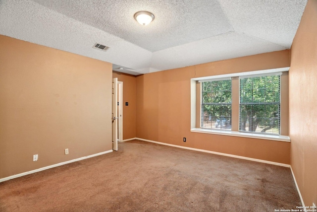 spare room featuring carpet flooring and lofted ceiling