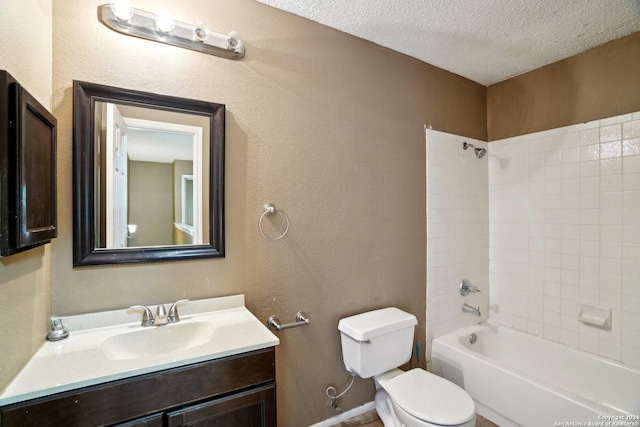 full bathroom with vanity, tiled shower / bath combo, a textured ceiling, and toilet