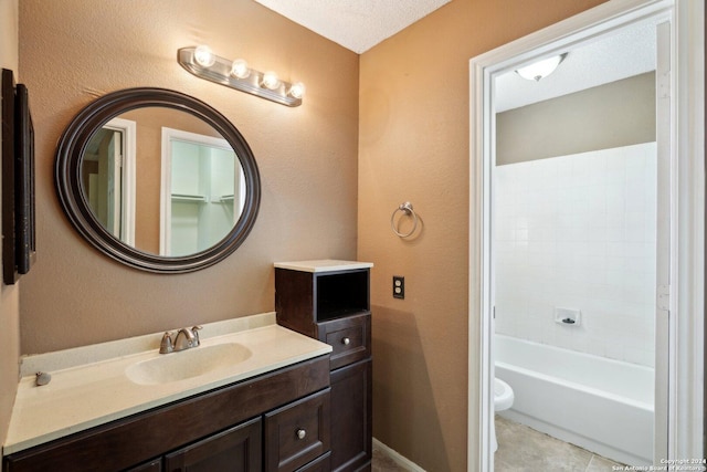 bathroom with tile patterned flooring, vanity, toilet, and a textured ceiling