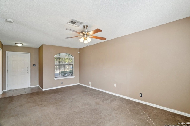 unfurnished room featuring carpet flooring, a textured ceiling, and ceiling fan