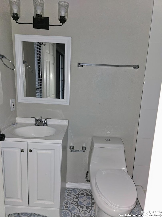 bathroom featuring vanity and toilet