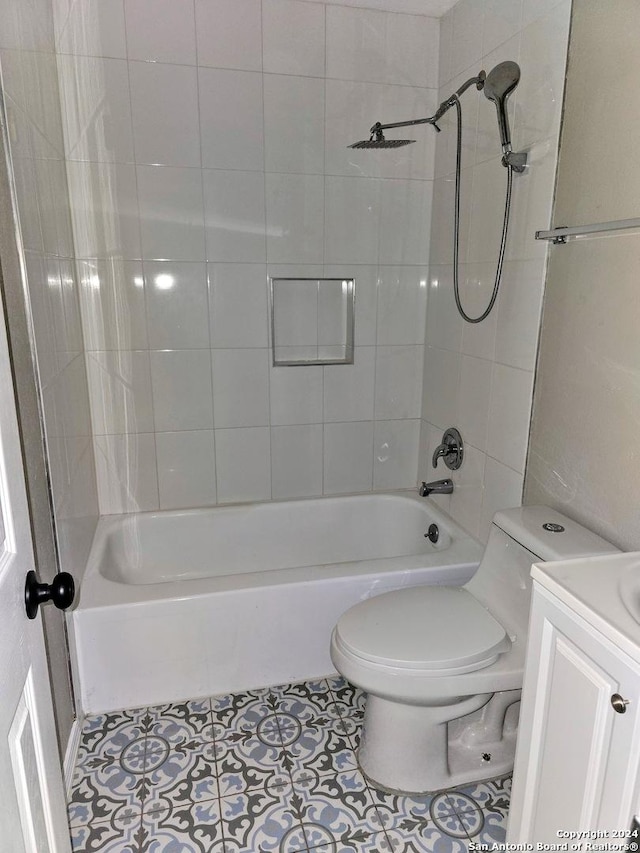 full bathroom with vanity, toilet, tiled shower / bath combo, and tile patterned flooring