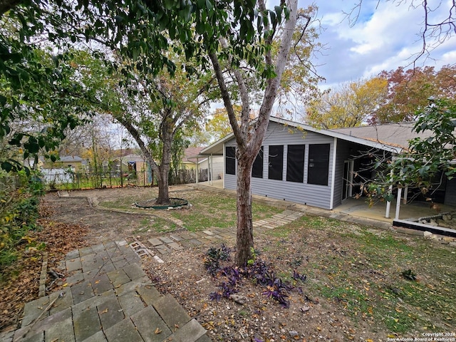 view of yard with a sunroom